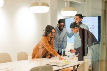 4 people working together around a table